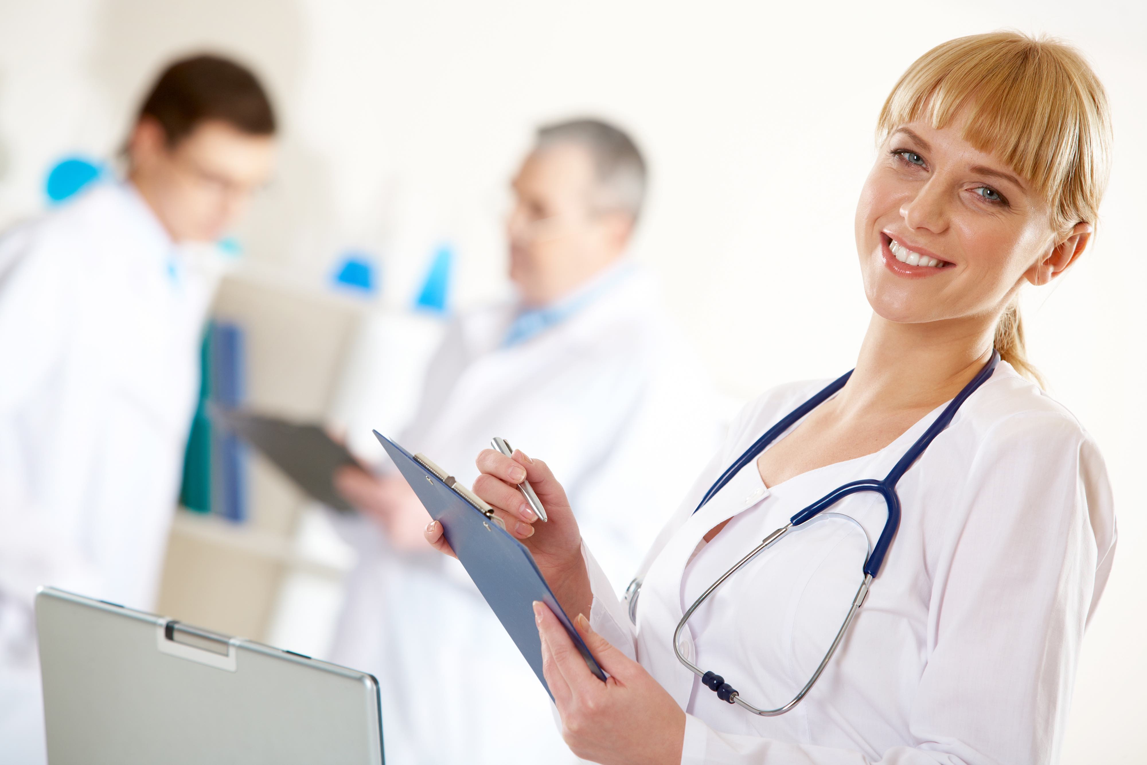 Portrait of friendly therapist looking at camera in working environment